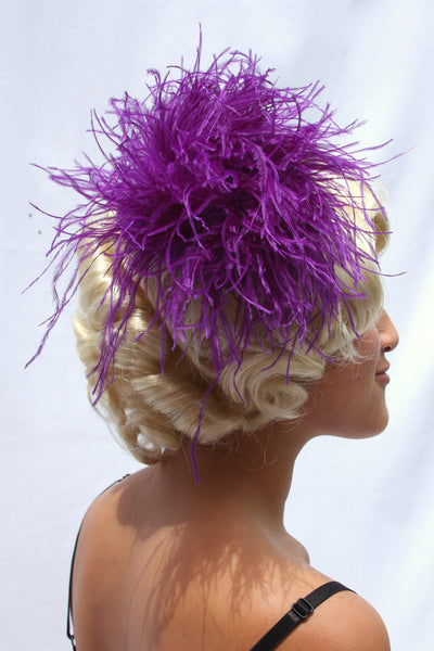 Our model is wearing the Ostrich Feather Hairclip in Purple.