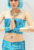 Our model is wearing the Short Sequins Tube Top in Turquoise AB.