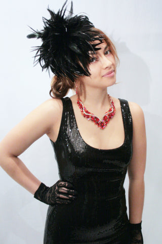 Our model is wearing the Fierce Rooster Feather Hairclip in Black Saddles Hackle.