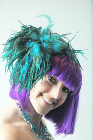 Our model is wearing the Fierce Rooster Hairclip in Turquoise Saddle Hackle.