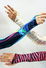 Our models are wearing the Gauntlet Gloves in Gold Zebra, Blue Swirl and Velvet Pink Zebra.